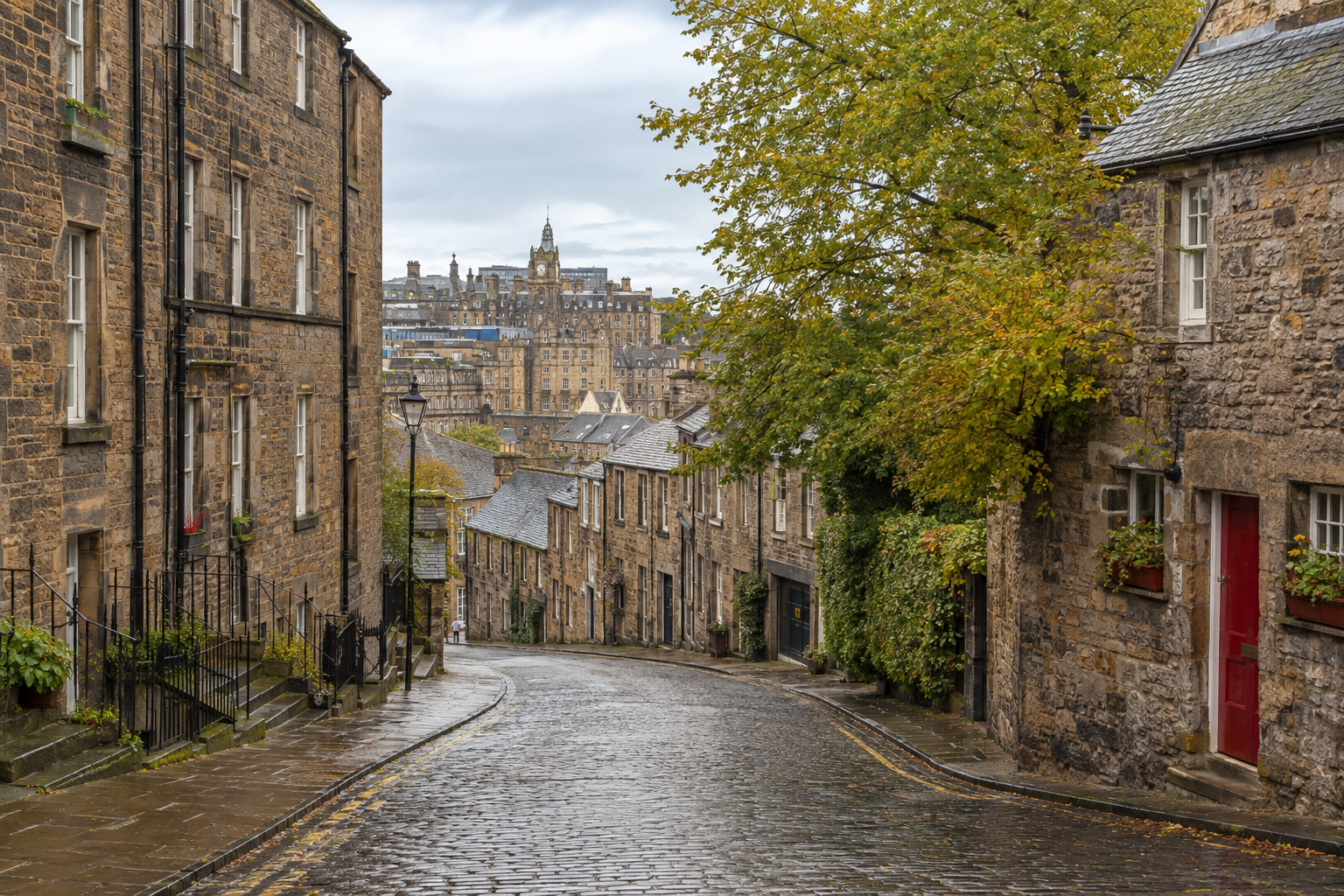 Edinburgh Old Town in soft gray weather with dark stone buildings, wet streets, and warm lights in the windows